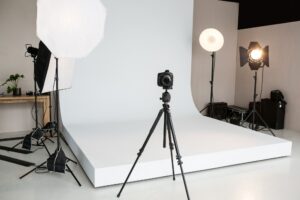 Photo studio with lighting equipment and digital camera